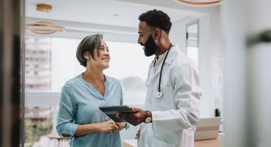 Male doctor speaking to female patient