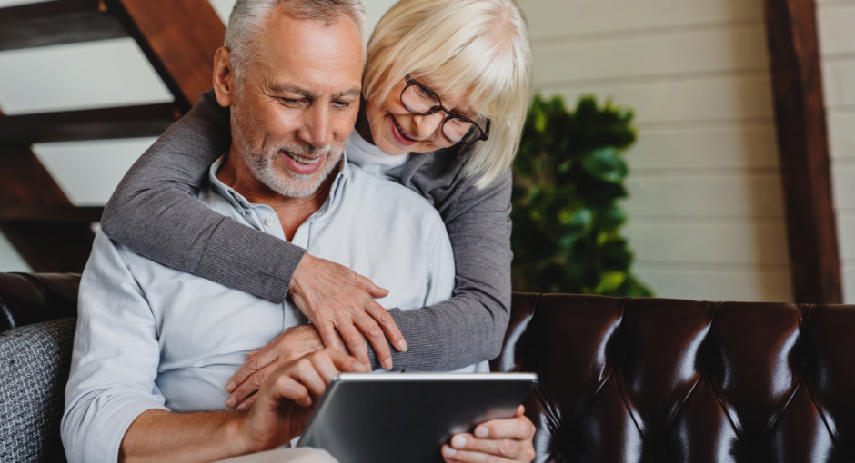 couple lovingly using tablet