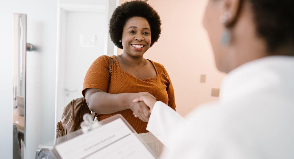 Patient shaking hands with her doctor