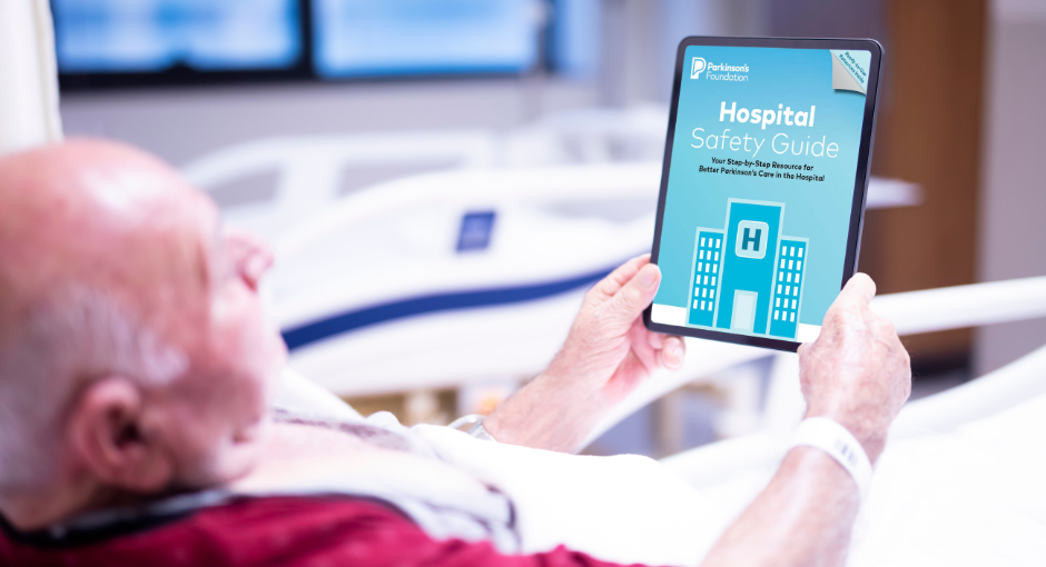 Man in hospital bed looking at Hospital Safety Guide on tablet