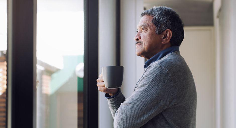 Man looking thoughtfully out the window