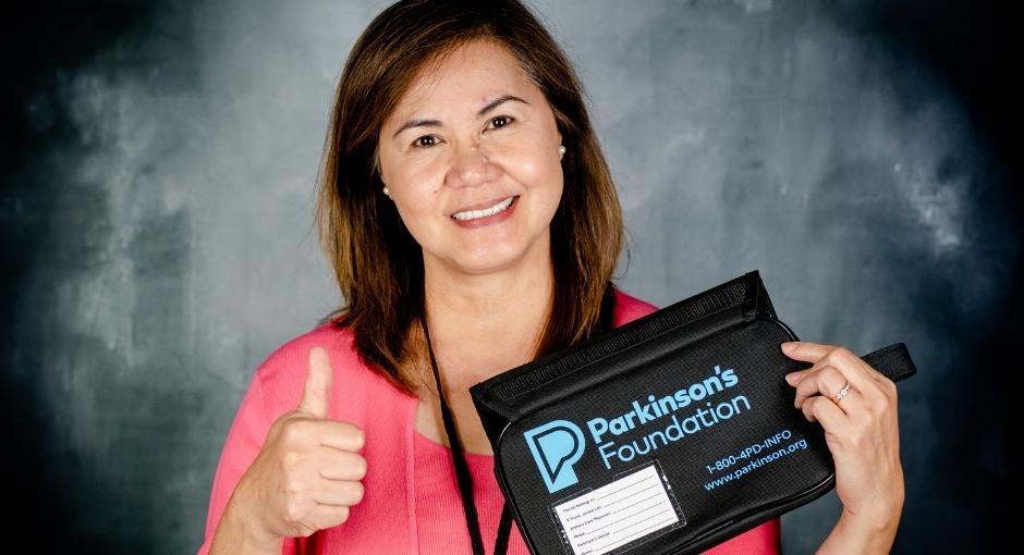 A woman holding a Aware in Care kit