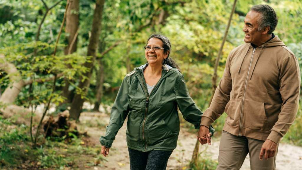 Man and woman having fun while walking in the woods