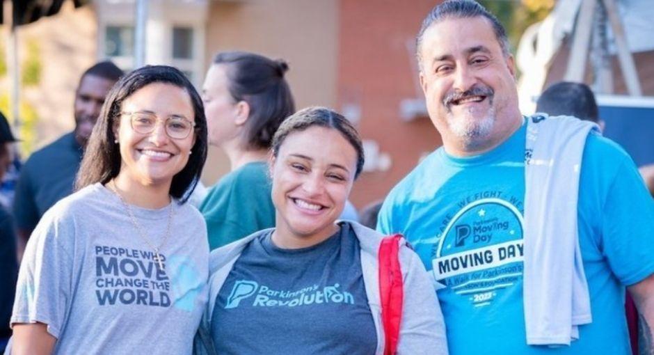 Three individuals at a Moving Day event