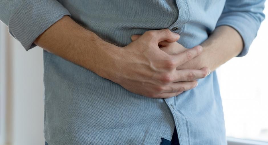 Man holding stomach in pain