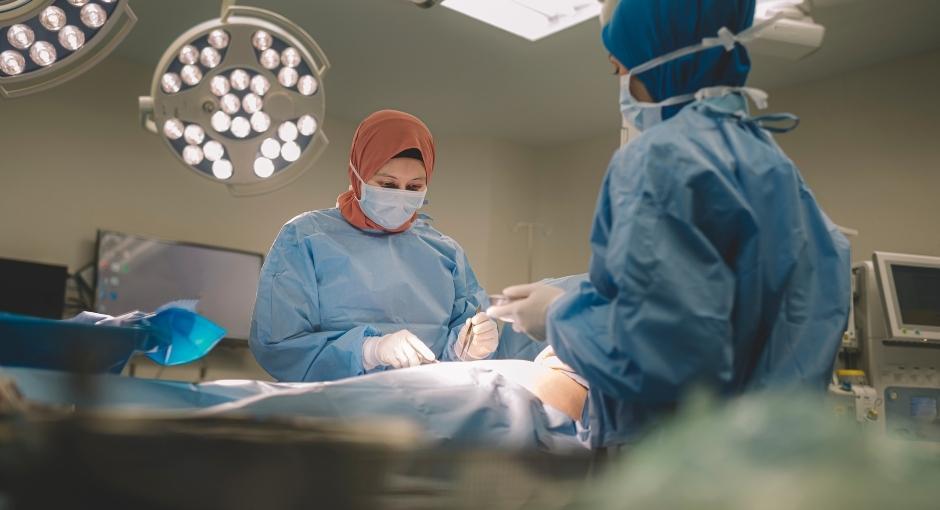 Two surgeons working on patient