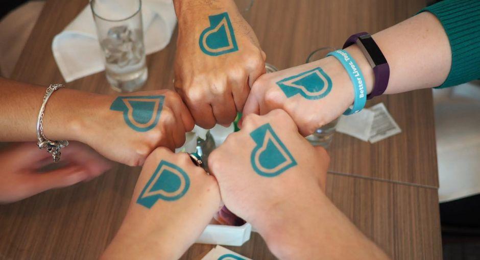 Image of hands with PF logo temporary tattoos