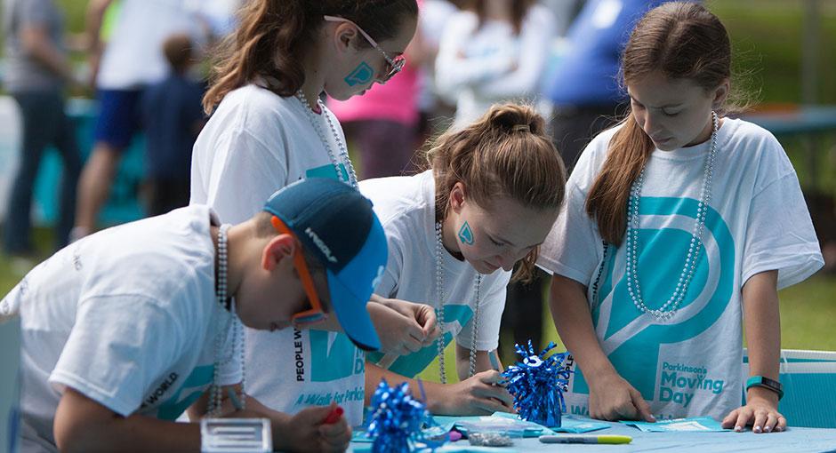 Children creating signs at the Moving Day walk for Parkinson's