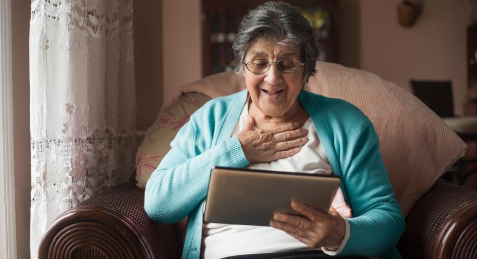 Woman happily looking at tablet