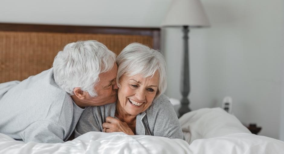 Couple cuddling in bed