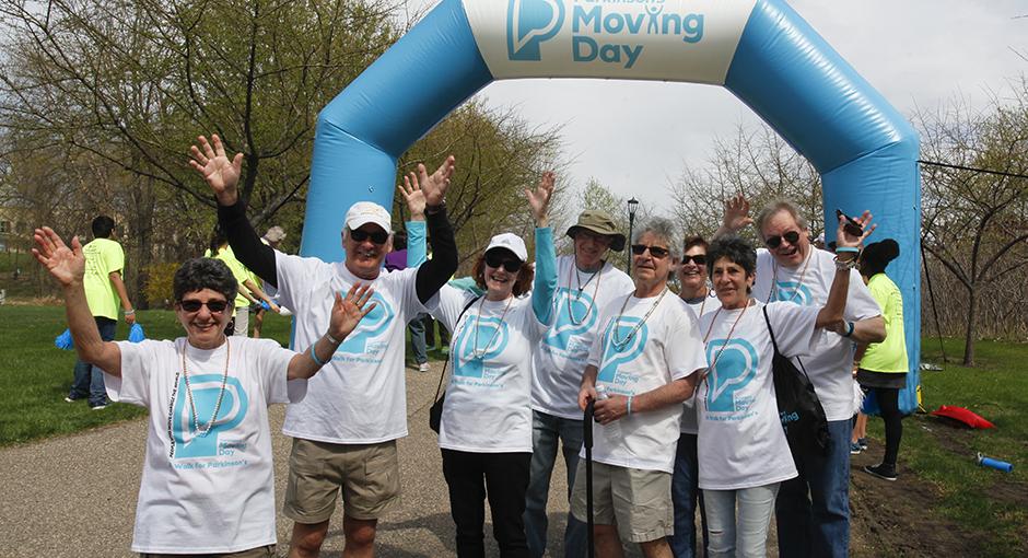 People cheering under a large arch at Moving Day