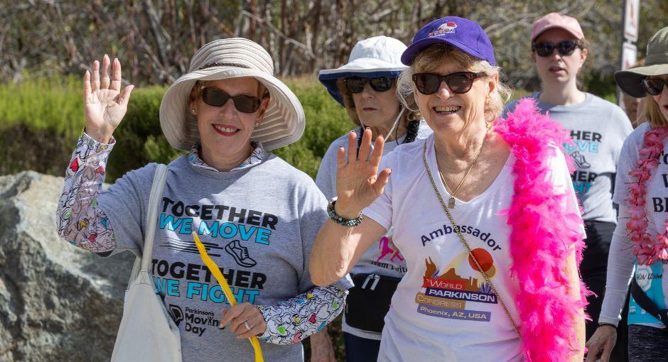 Women waving as they walk for Parkinson's Moving Day