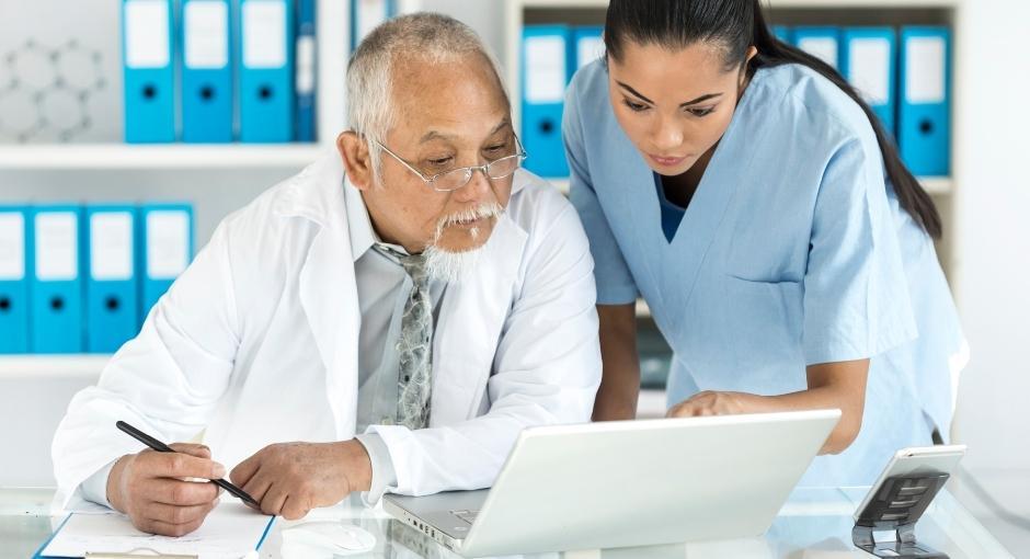 Doctor and nurse looking at laptop