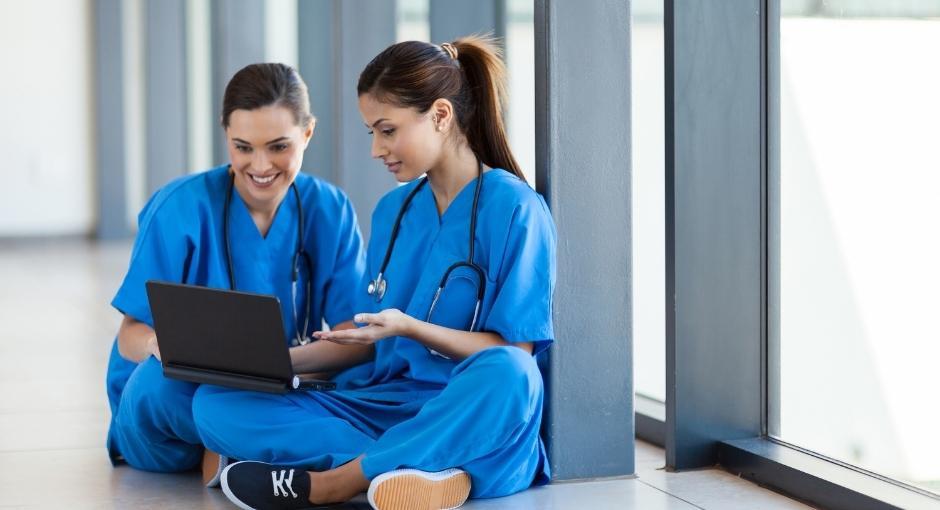 Two nurses looking at laptop