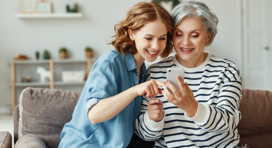 grandma and granddaughter using an iphone