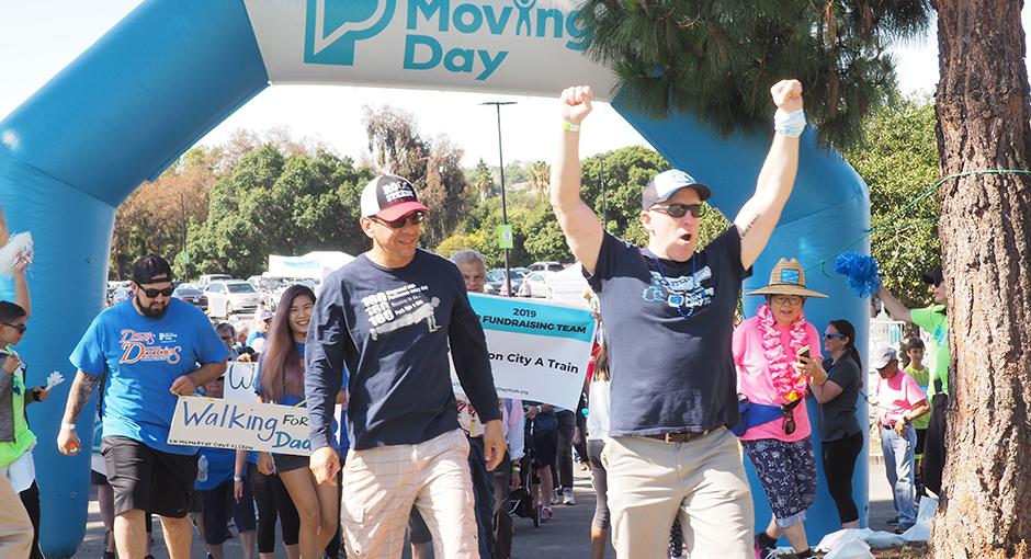 People celebrating at the Moving Day finish line