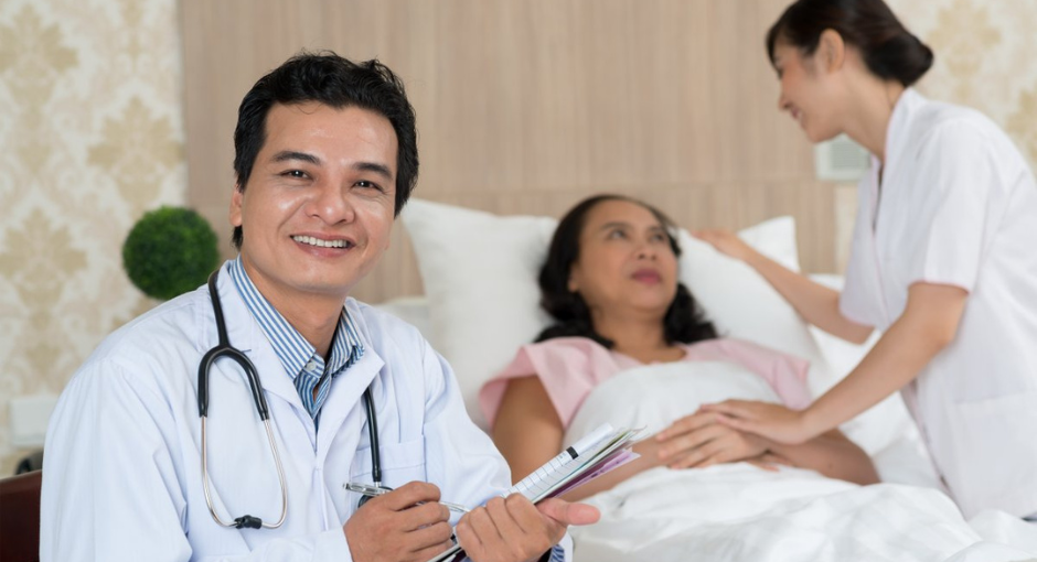 Doctor with patient in a hospital bed