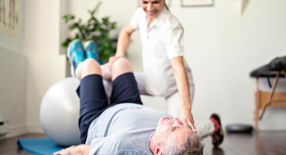 Physical therapist helping patient