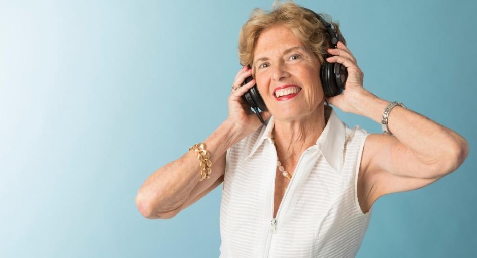 Lady with headphones on listening to a podcast