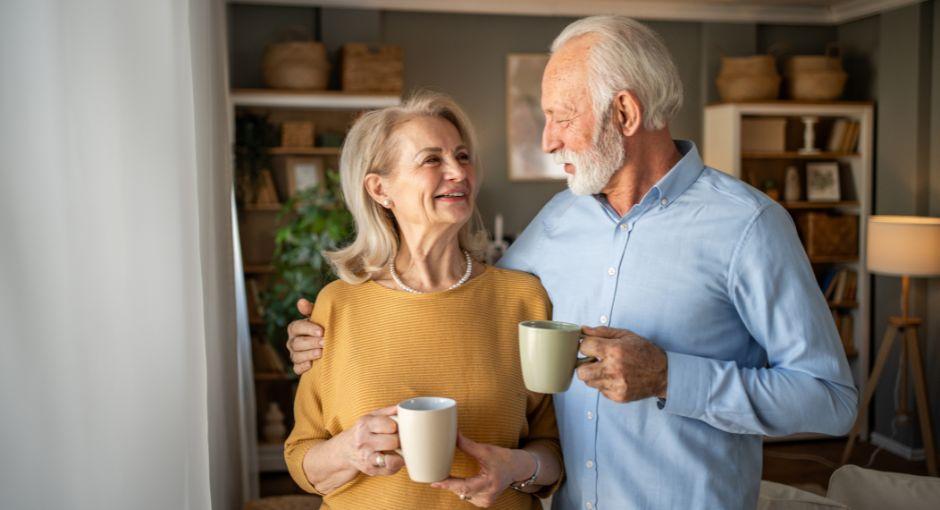 Elderly couple enjoying coffee together at home