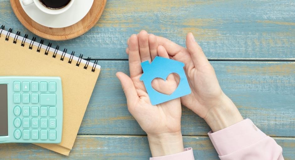 Stock photo of person holding a house