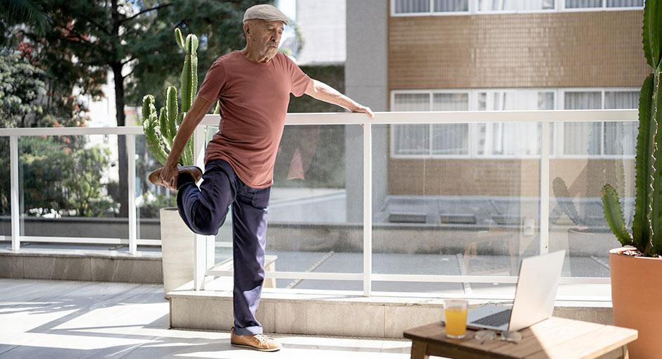 Older man stretching during an online exercise class