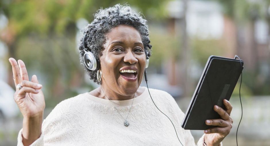 lady wearing headphones listening to a tablet