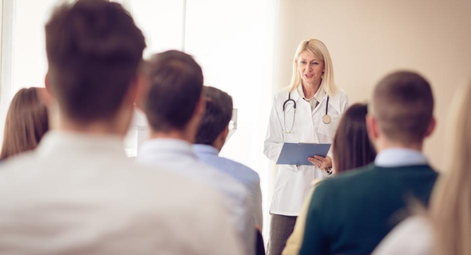 Nurse talking in front of group