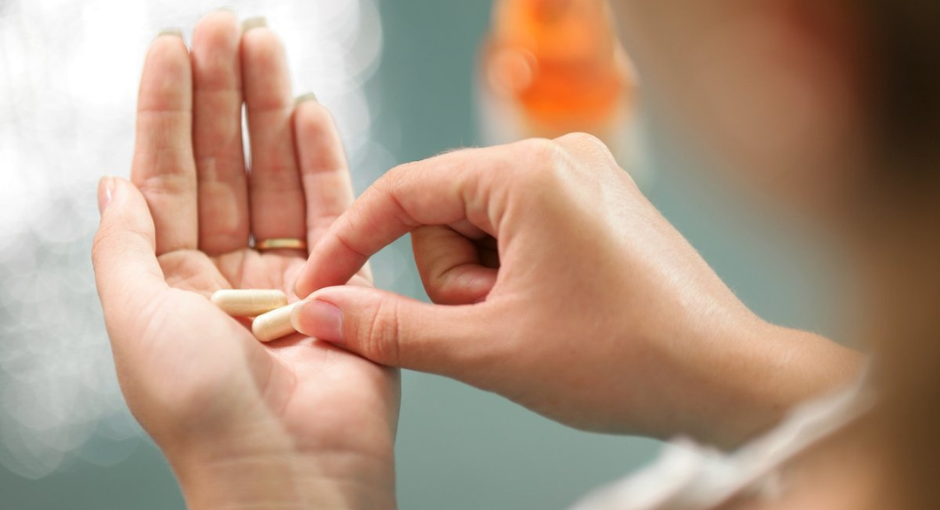 Woman holding a pill