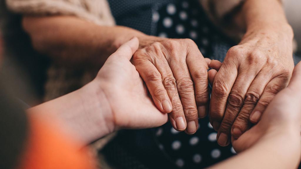 group of hands holding on to each other