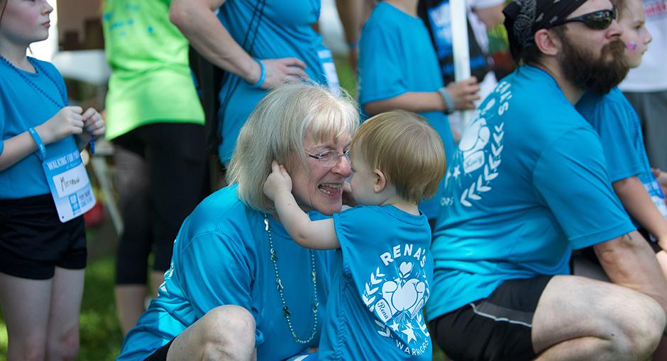 Woman and young child embracing with smiles at Moving Day