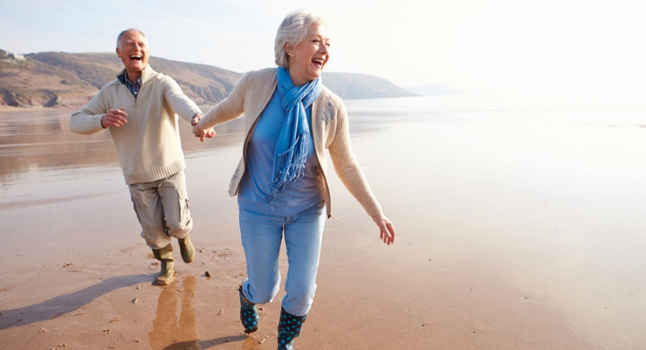 2 people walking on the beach