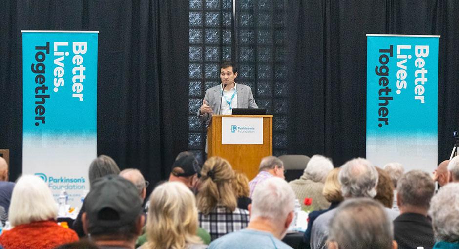 Speaker at a podium during a Parkinson's Foundation event