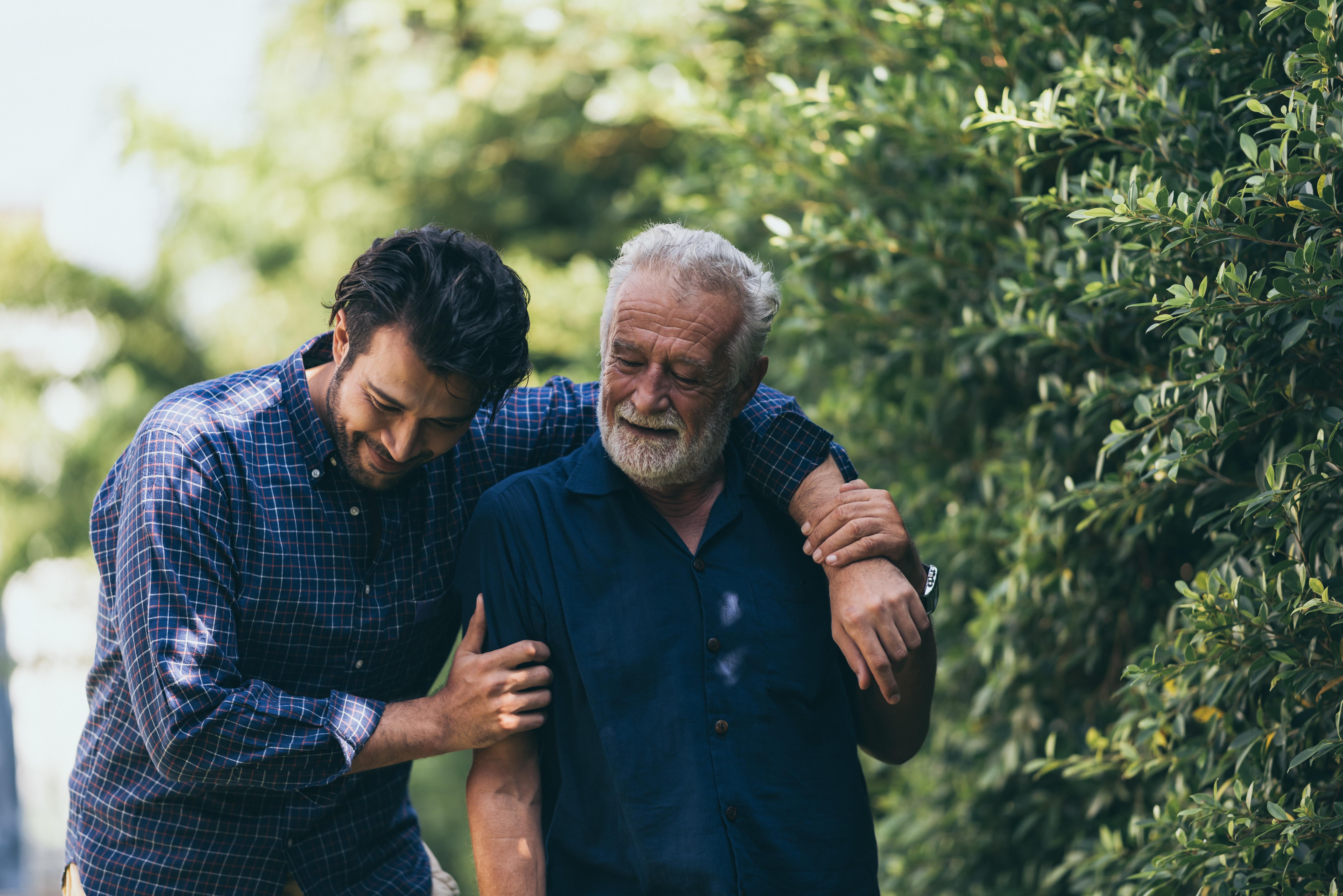 Father and son walking and hugging