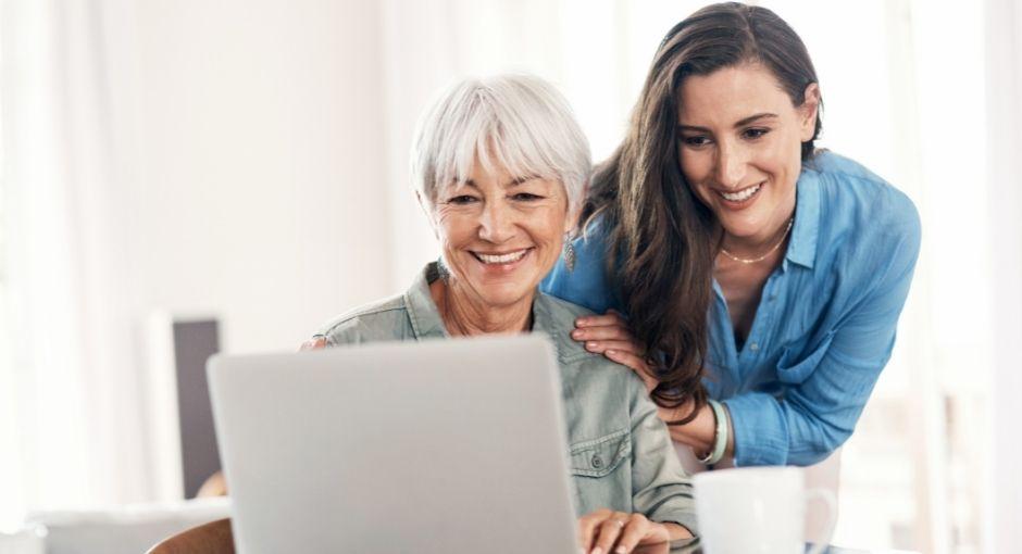 Mother and daughter looking at laptop together