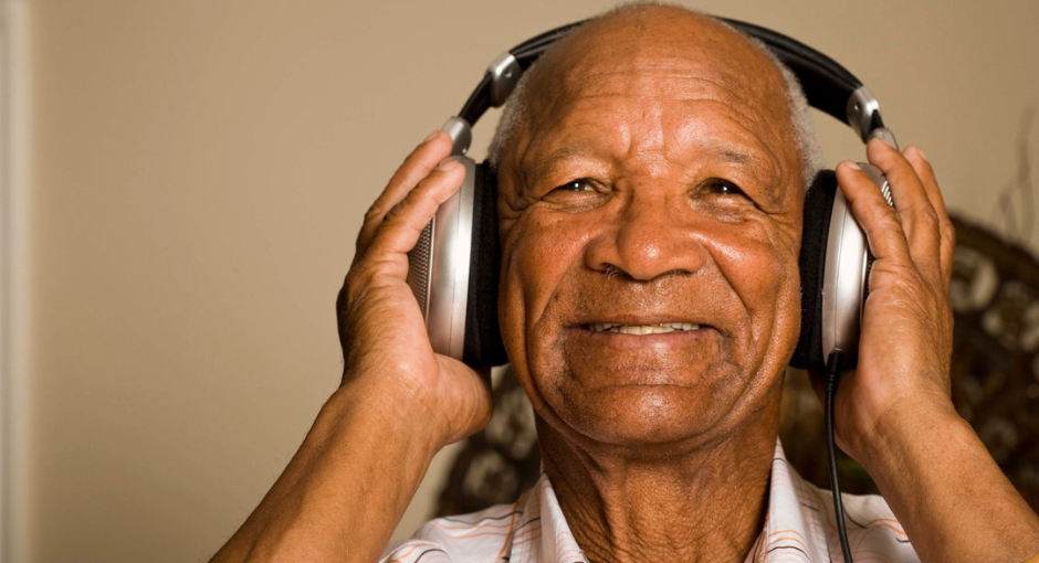 Man smiling and listening to headphones