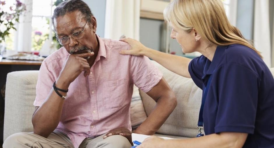 Man sitting on couch with counselor