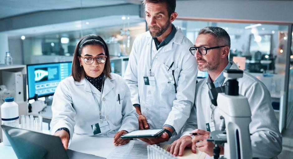 Researchers in a lab looking at a computer