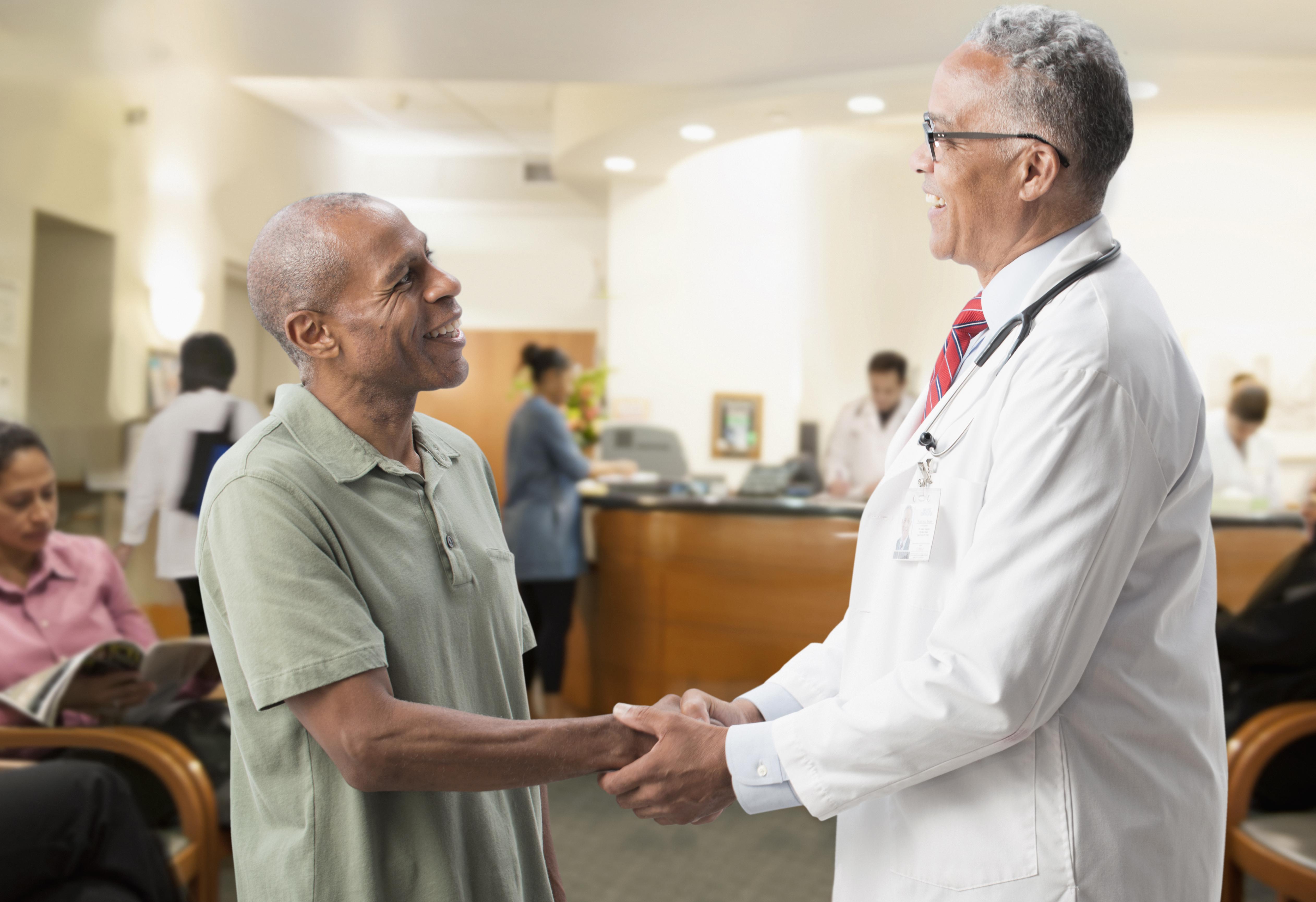 Doctor holding hands with patient