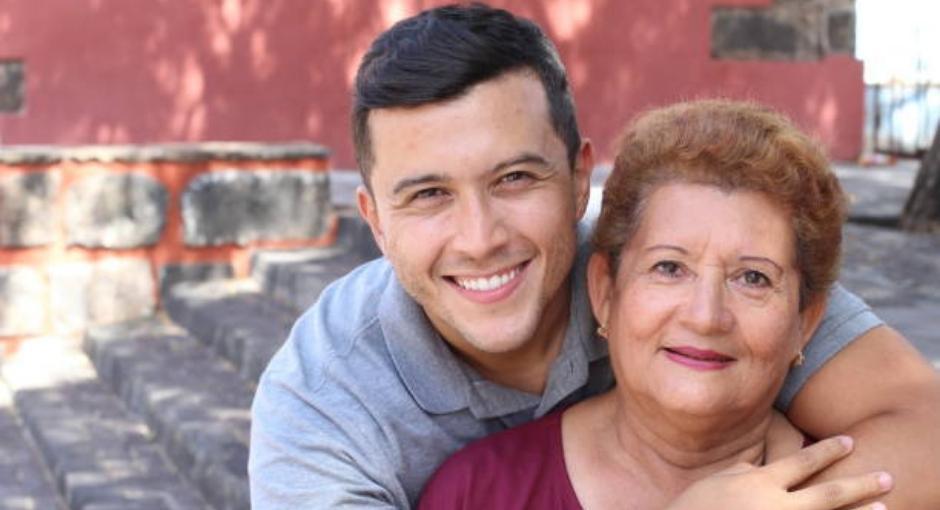 Hispanic son hugging his mother
