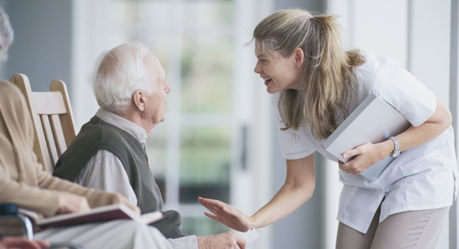 Older man talking to nurse