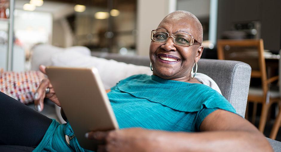 Wellness Wednesday banner - woman with tablet smiles at camera