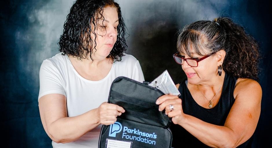 Two ladies opening Aware in Care Kit