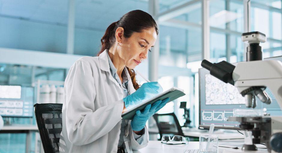 Researcher taking notes in a lab